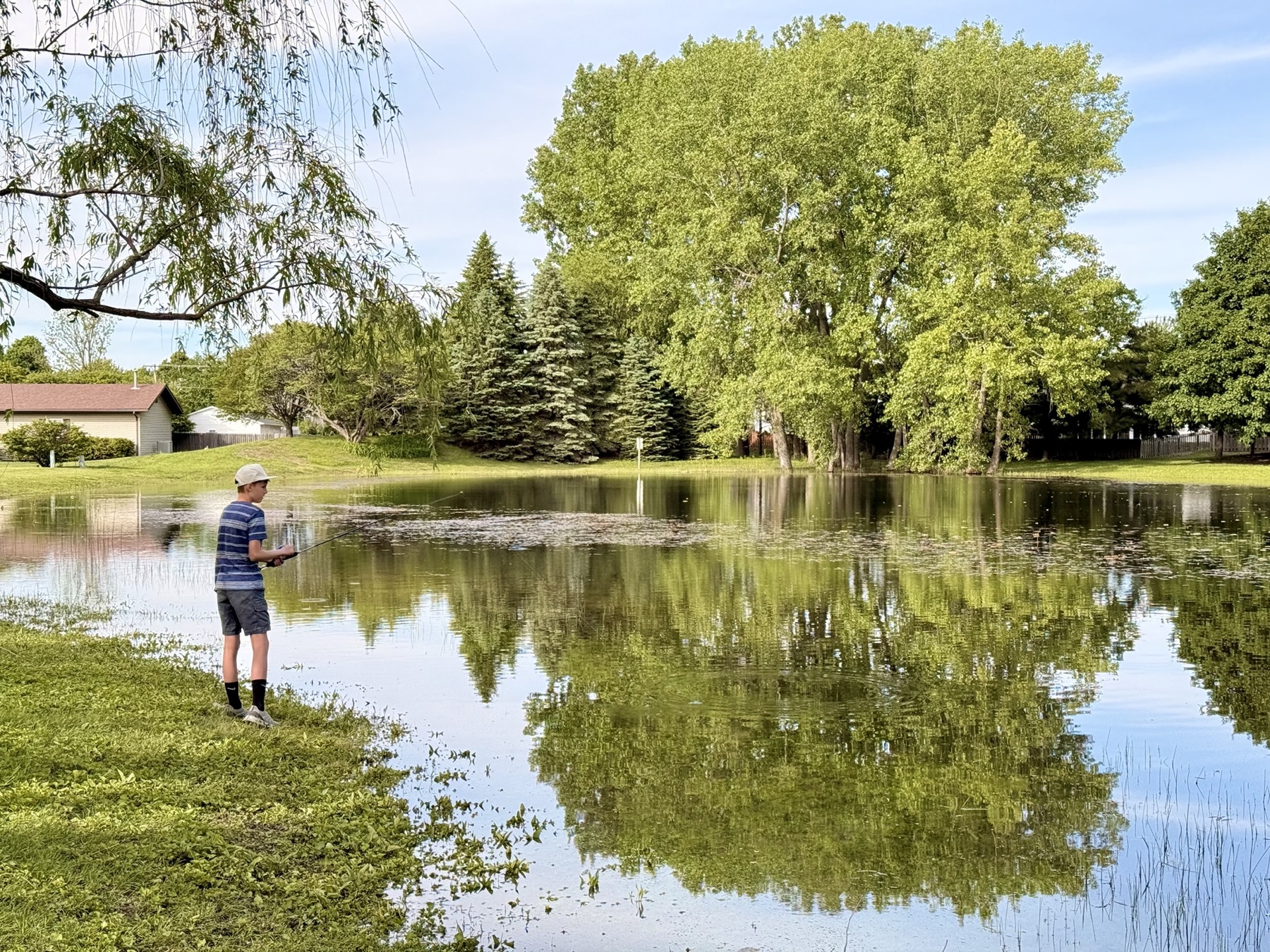 A resident fishing at the West Road Park pond